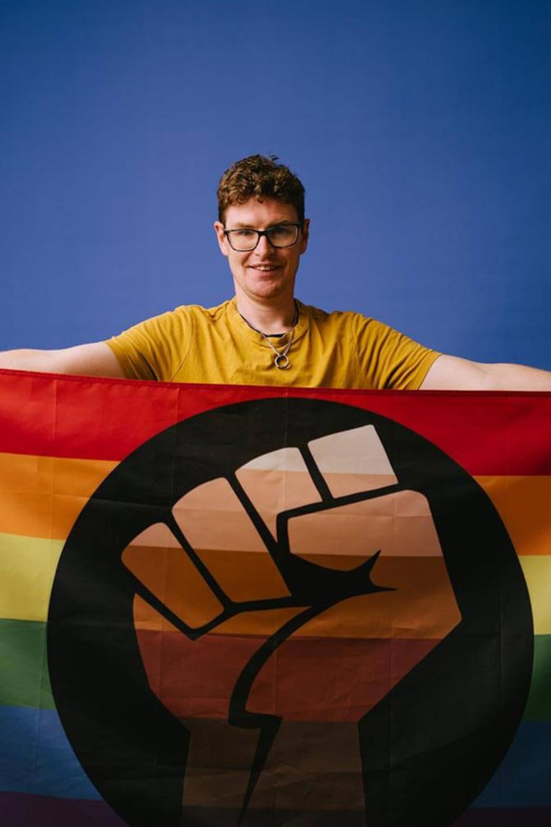 Mitch with Pride flag Mitch with Pride flag